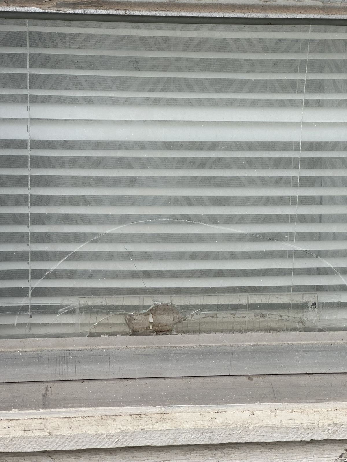 Cracked window glass with visible impact point