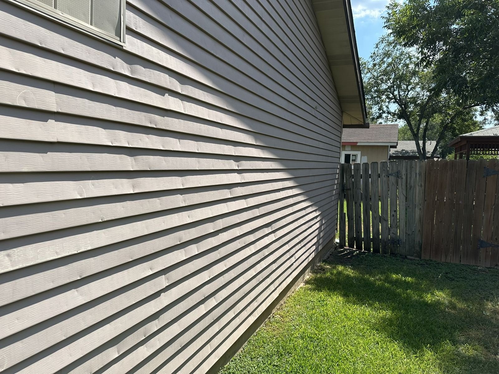 Exterior siding inspected for hail impact marks