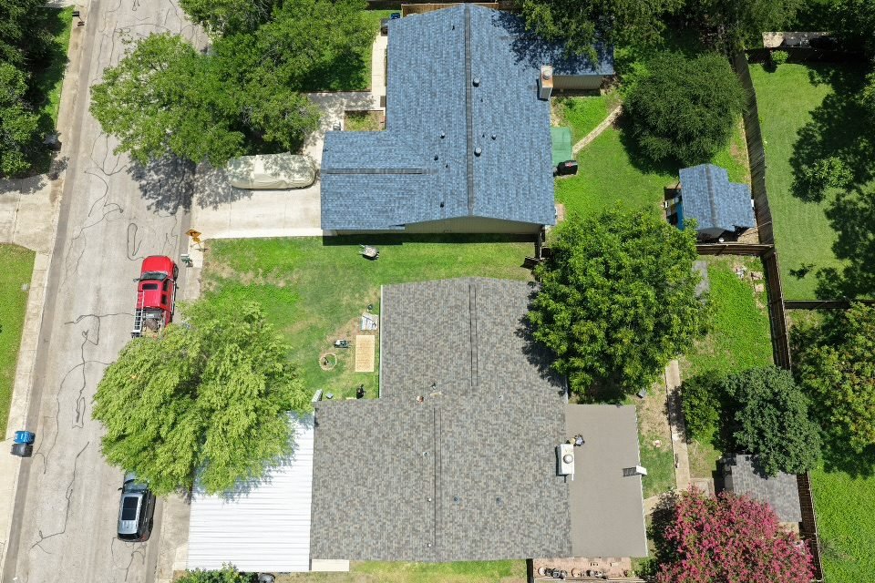 Aerial view of a completed shingle roof installation