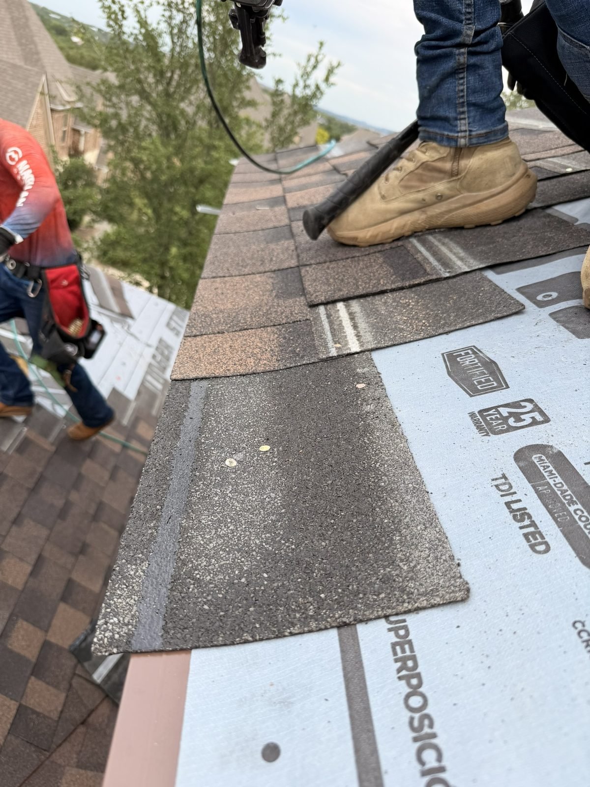 Close-up of shingle installation showing underlayment detail